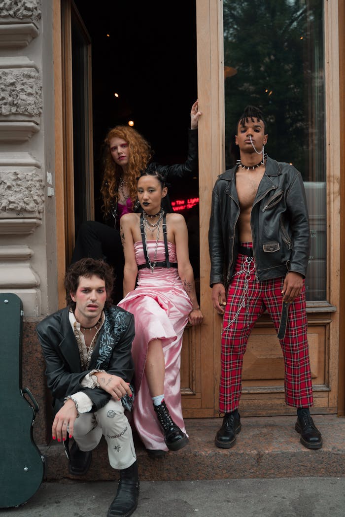 A group of stylish individuals showcasing creative fashion in an urban doorway.